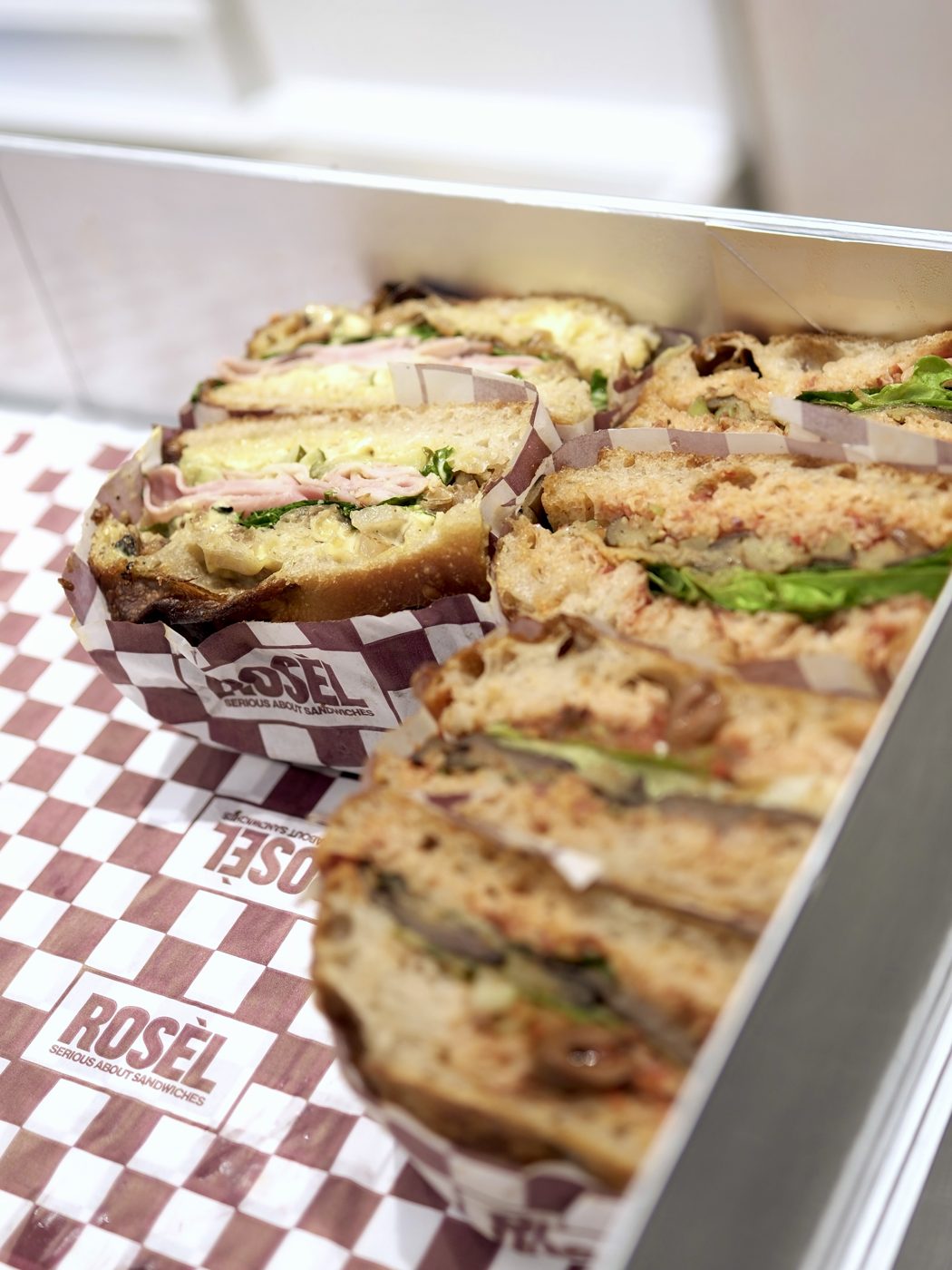 Sandwiches lined up in a Rosèl catering box